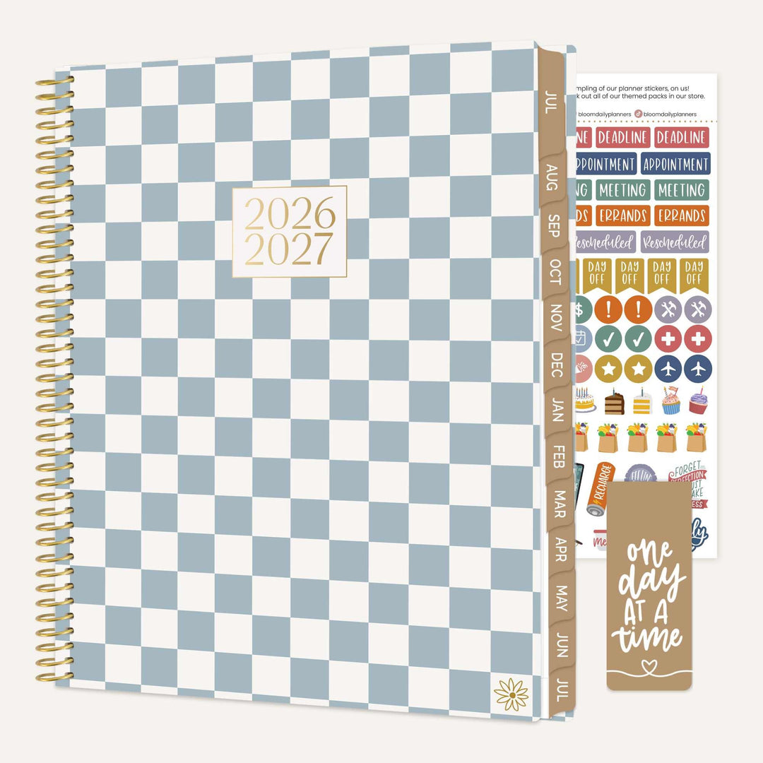 Checkered planner with stickers and motivational quote on a white background