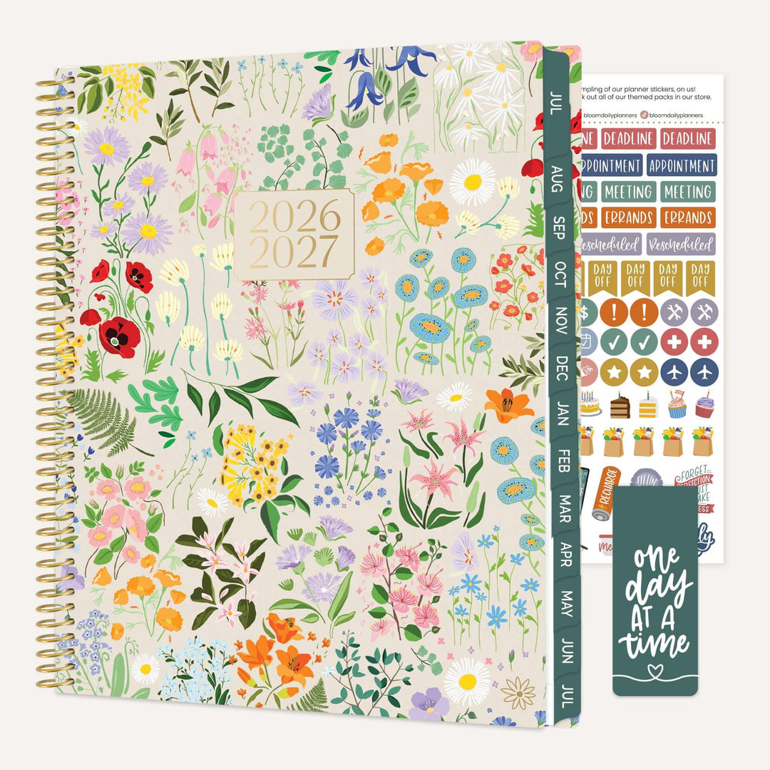 Floral-patterned planner with stickers and a motivational quote on a white background