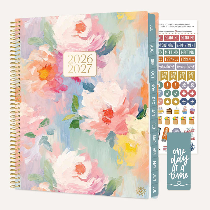 Floral design planner with stickers and motivational quote on a white background