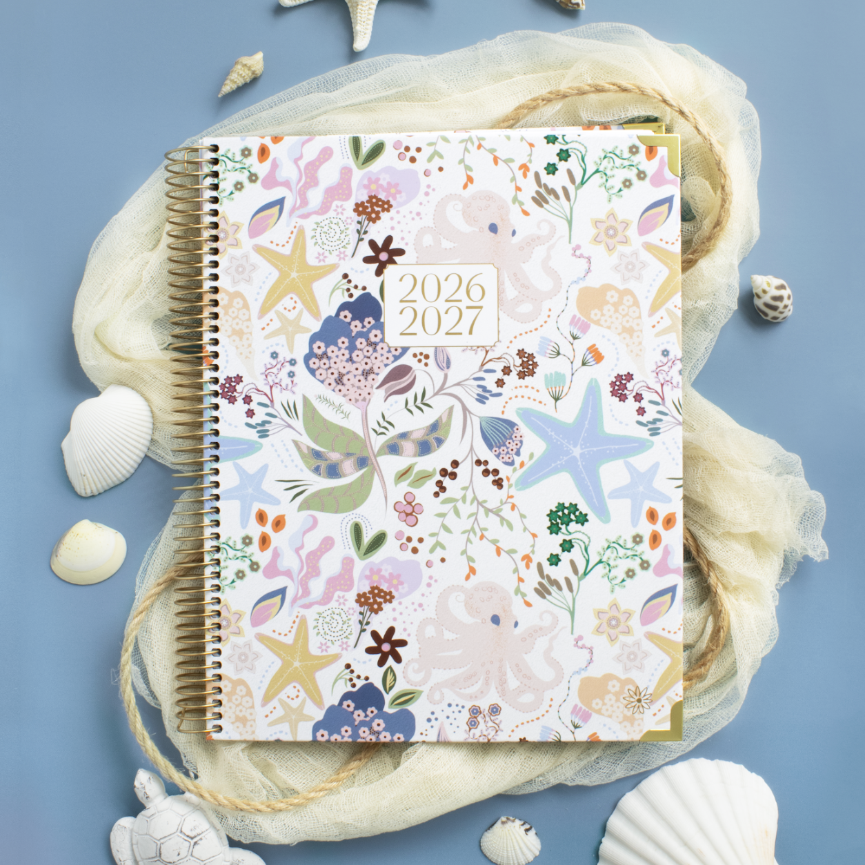 2026-2027 planner with sea-themed design on a blue background with shells and coral.