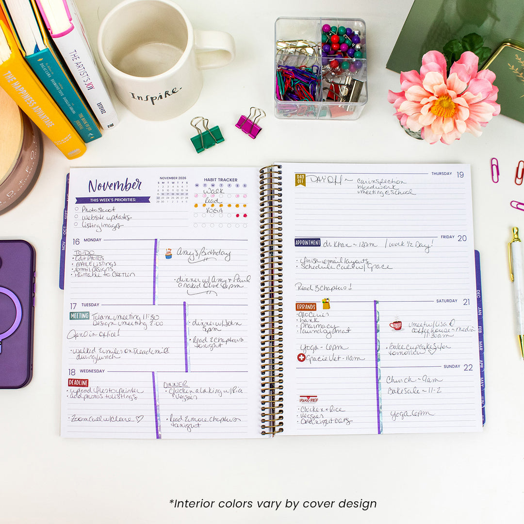 Open planner with November monthly layout on a desk with stationery items