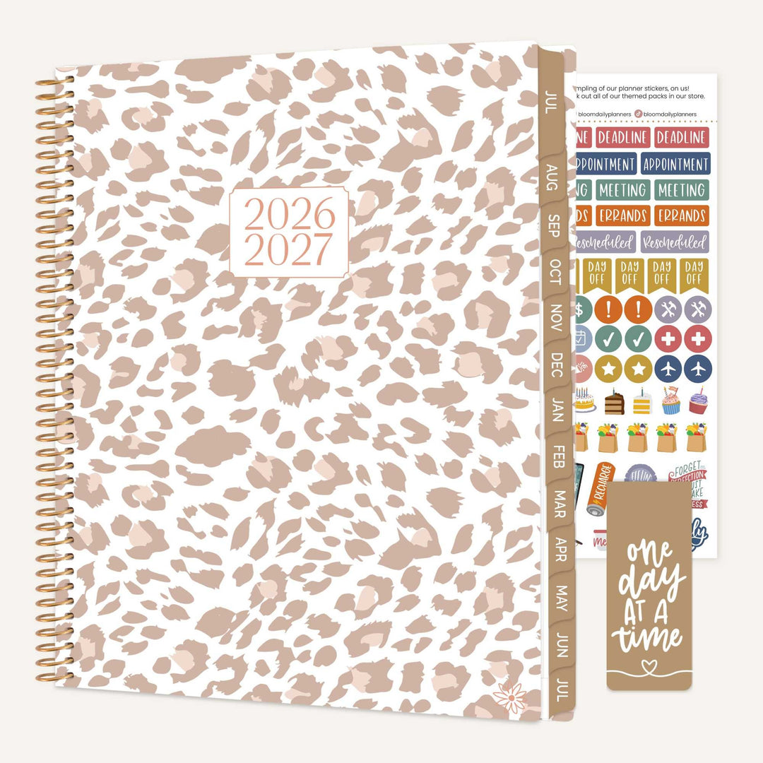 Leopard print planner with stickers and motivational quote on a white background