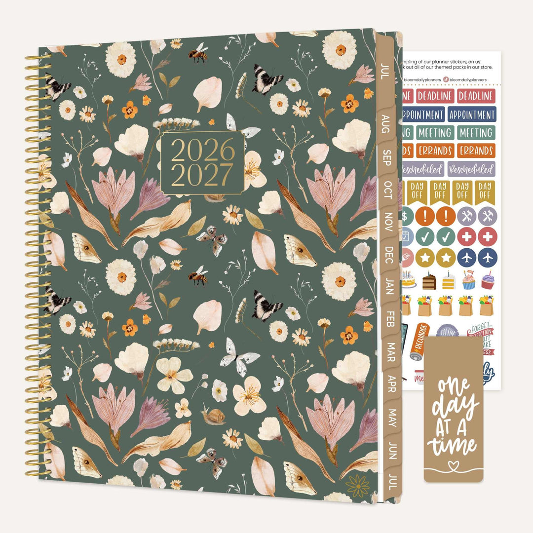 Floral-patterned planner with stickers and a quote card on a white background
