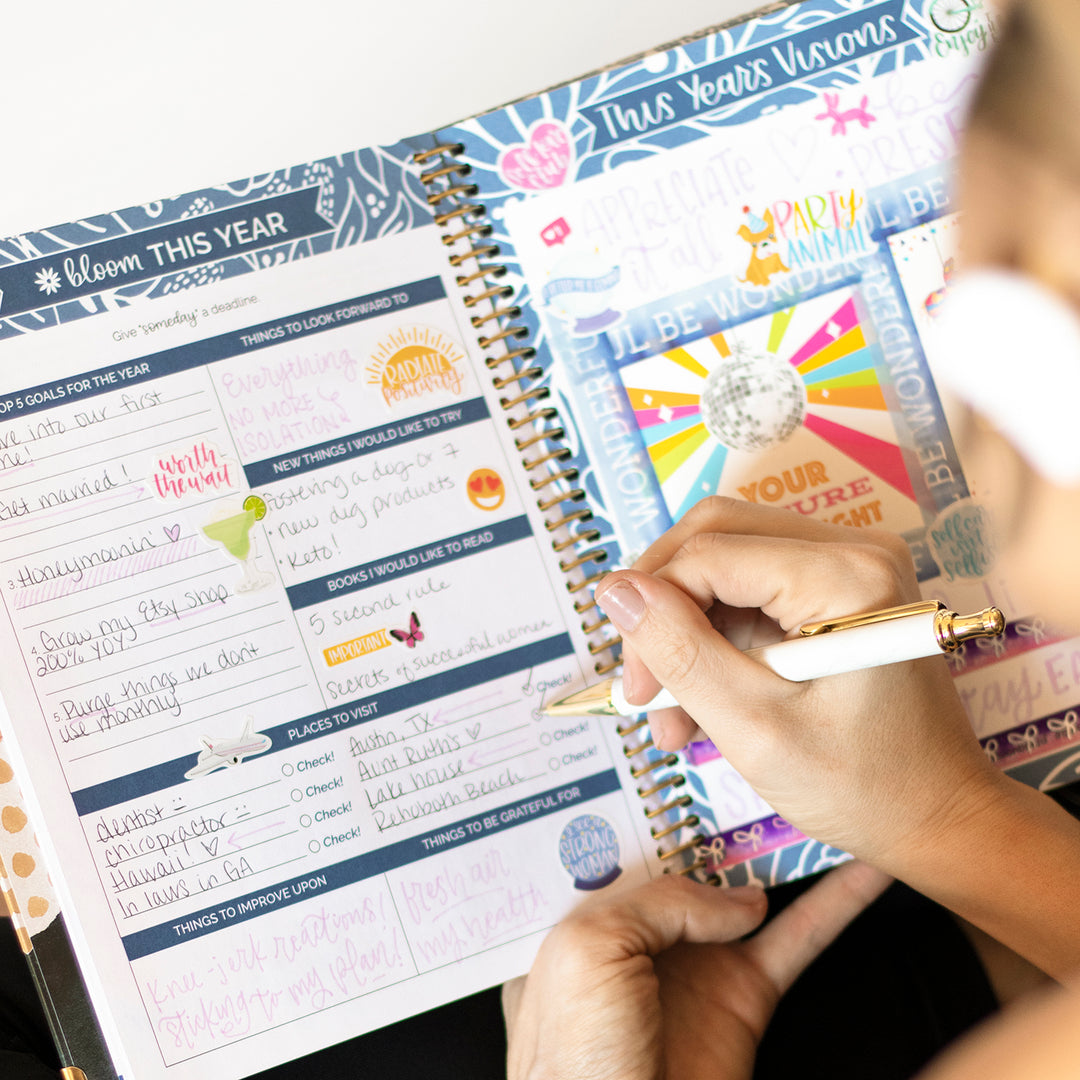 girl writing in her bloom vision planner
